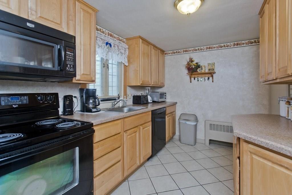 17 Arthur Street Springfield, MA 01104 - Photo 14 of 36 a kitchen with a stove and a microwave
