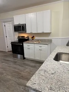 a kitchen with a sink a stove and cabinets