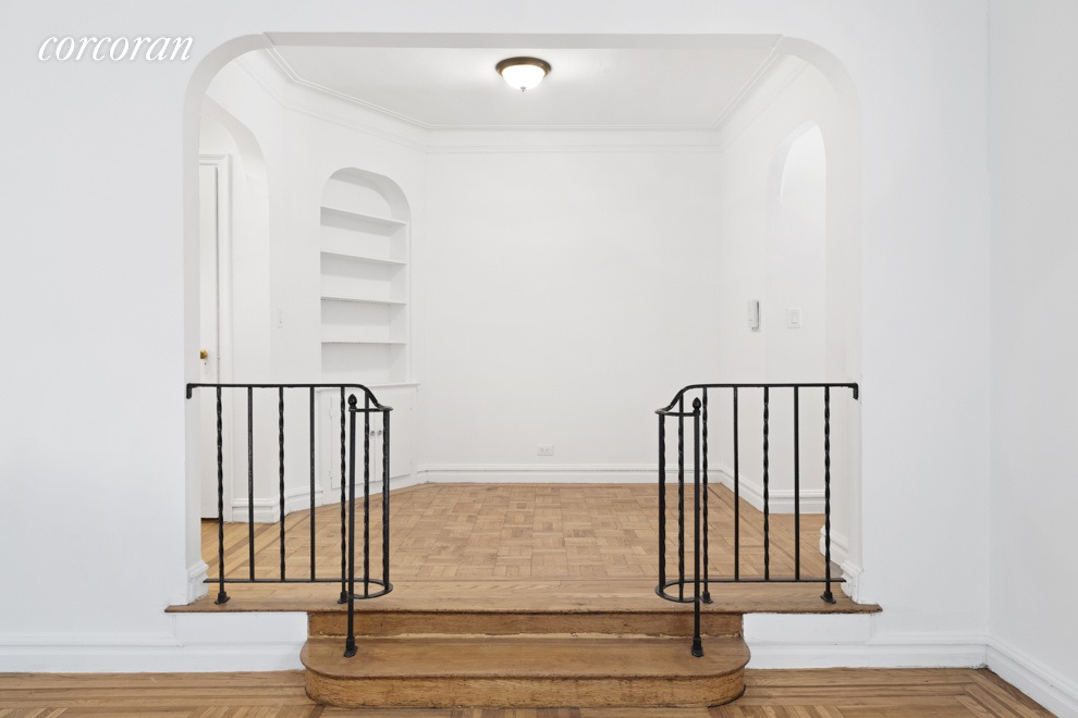 a view of staircase with white walls and railing
