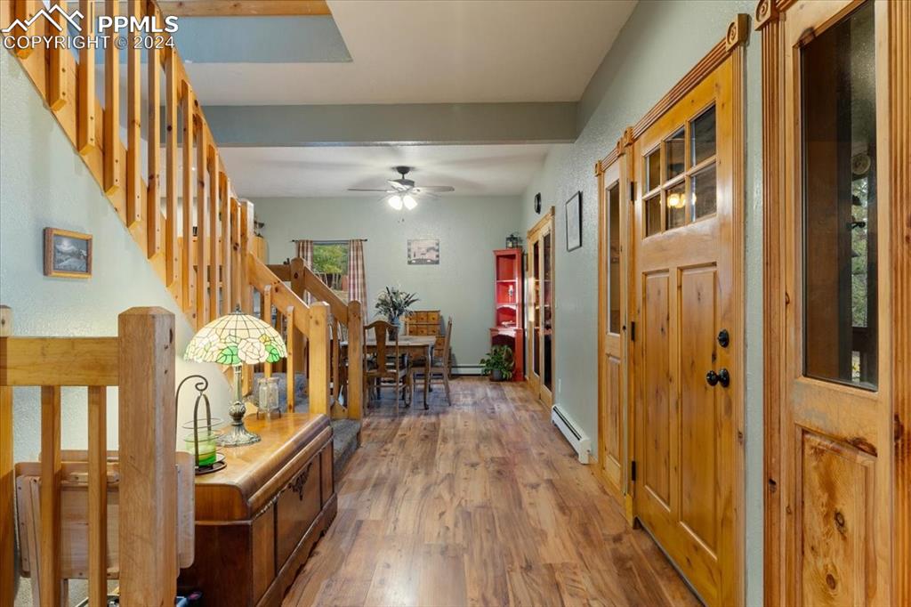 123 Maroon Lake Circle Divide, CO 80814 - Photo 13 of 47 a view of a hallway with wooden floor and staircase