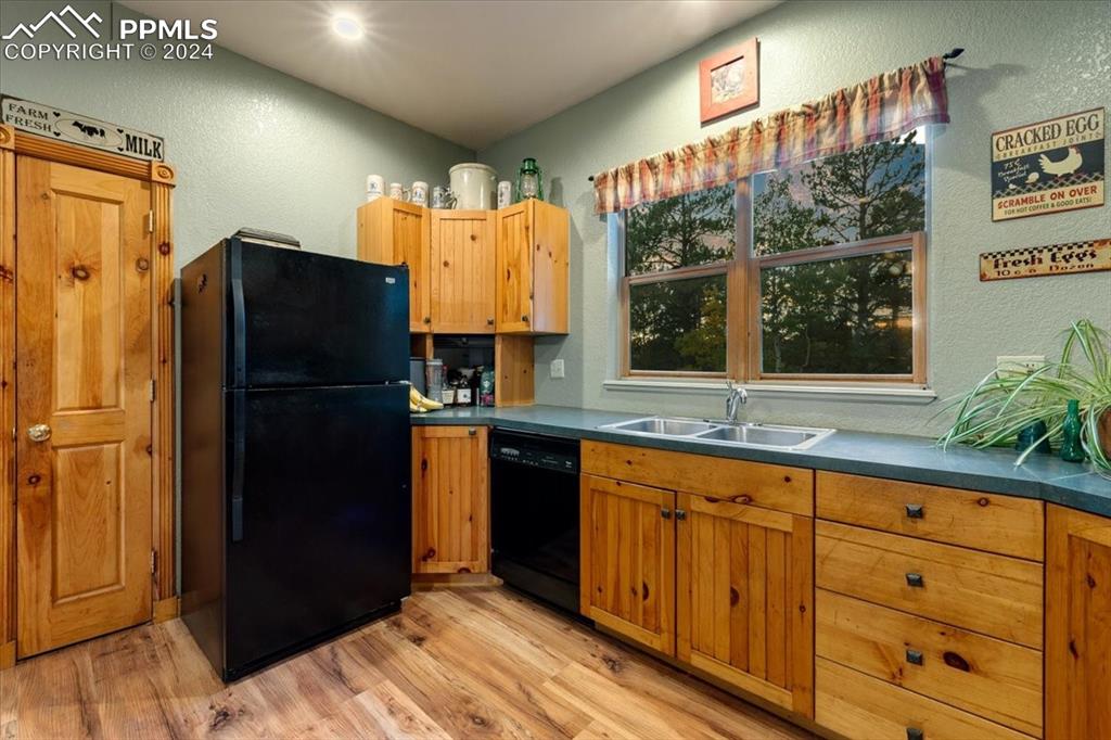 123 Maroon Lake Circle Divide, CO 80814 - Photo 18 of 47 a kitchen with granite countertop a refrigerator and a sink