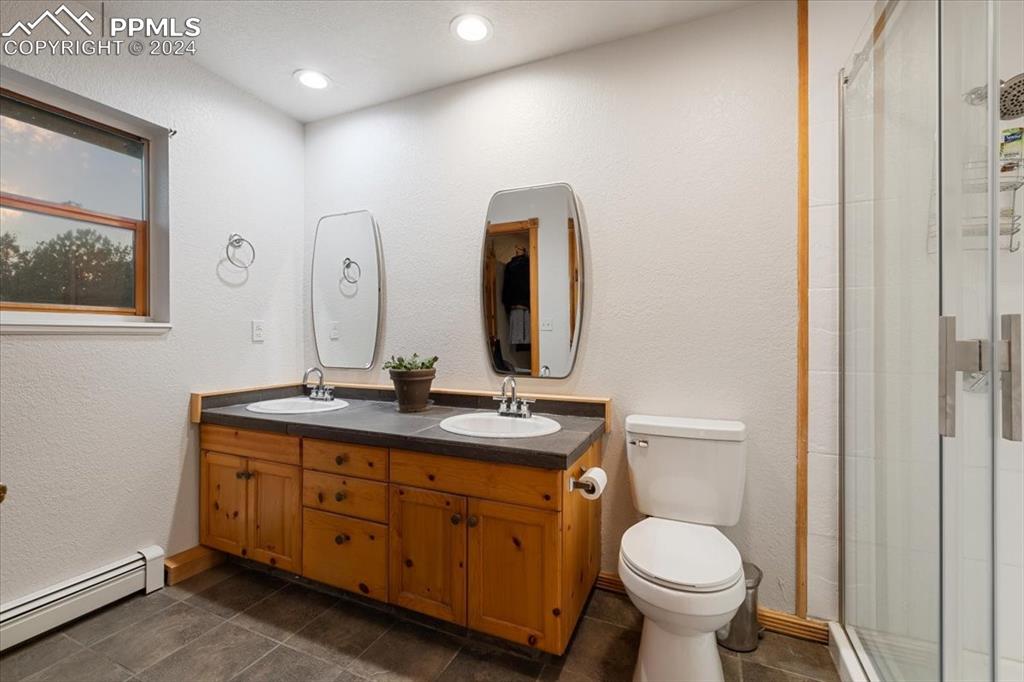 123 Maroon Lake Circle Divide, CO 80814 - Photo 36 of 47 a bathroom with a toilet sink and mirror