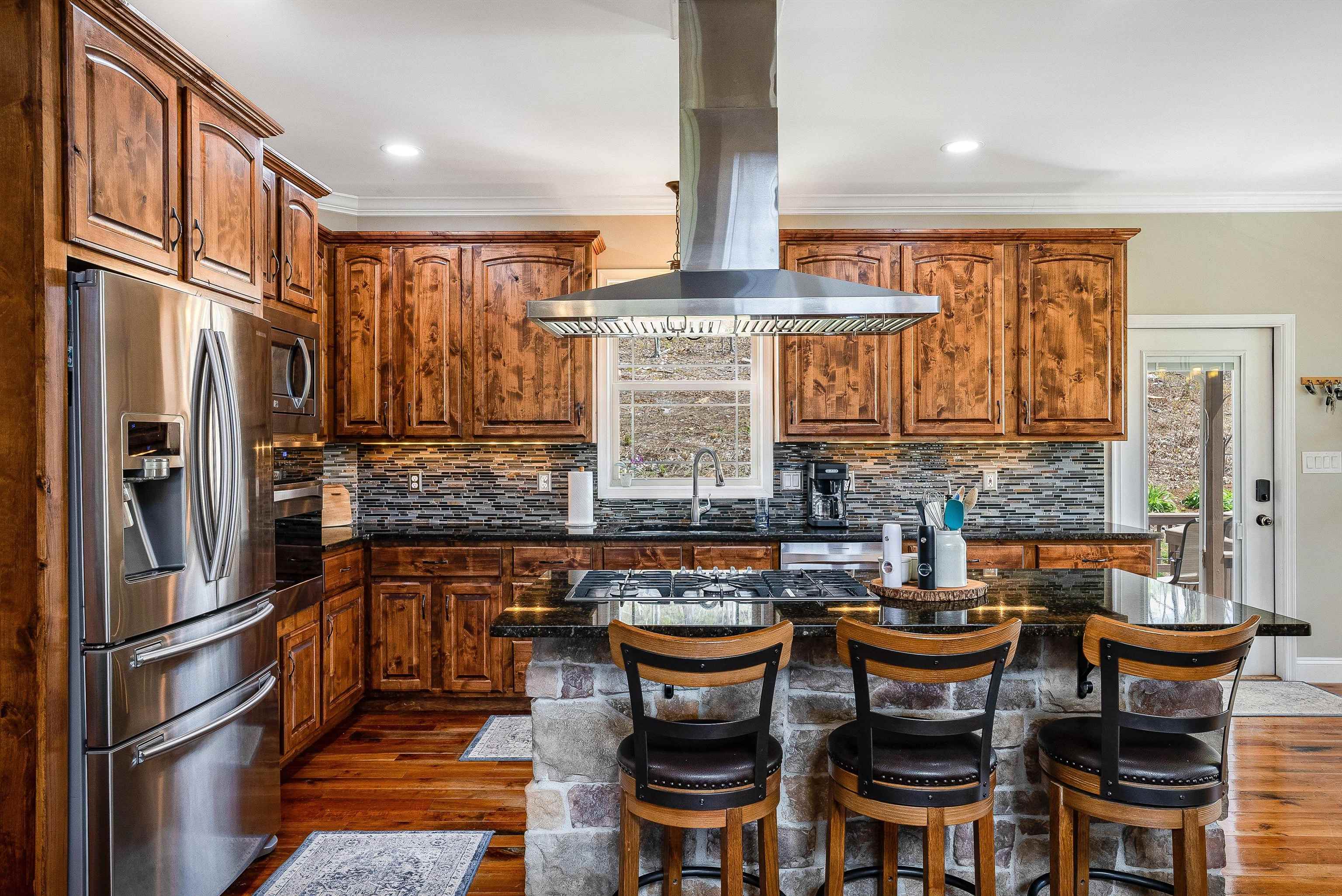 920 Wagon Shop Road Middlebrook, VA 24459 - Photo 14 of 75 a kitchen with stainless steel appliances granite countertop a table chairs in it and wooden floors