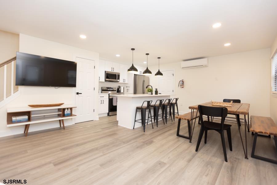 110 West Buttercup Road, Unit 5 Wildwood Crest, NJ 08260 - Photo 11 of 31 a living room with furniture and a flat screen tv