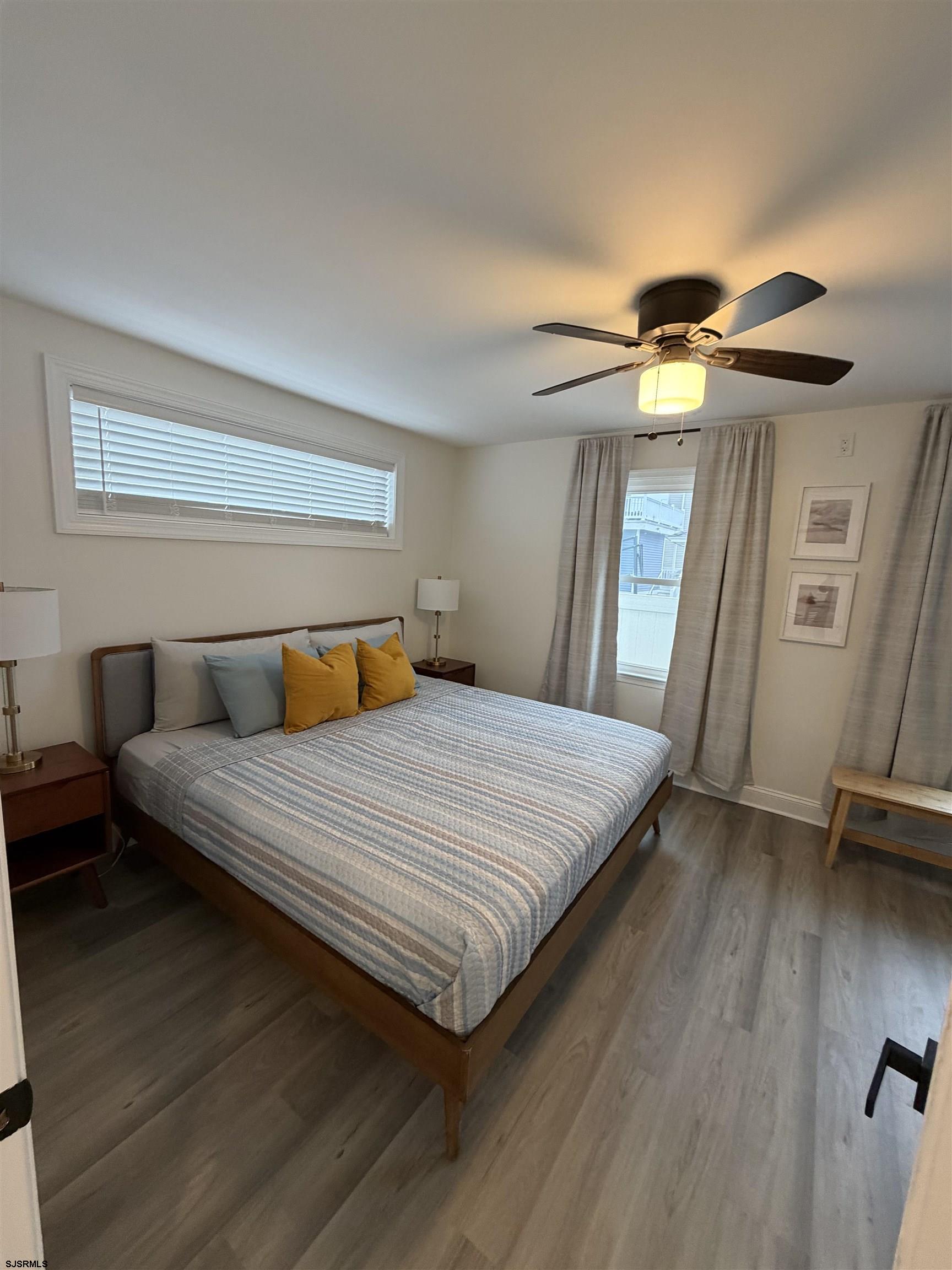 110 West Buttercup Road, Unit 5 Wildwood Crest, NJ 08260 - Photo 18 of 31 a bedroom with a bed and a mirror