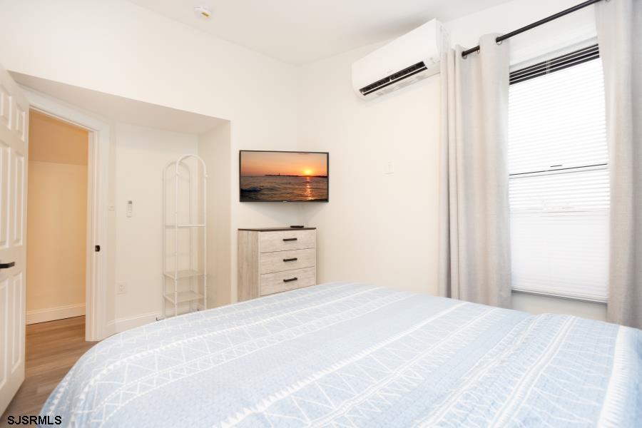 110 West Buttercup Road, Unit 5 Wildwood Crest, NJ 08260 - Photo 20 of 31 a bedroom with a bed and a flat screen tv