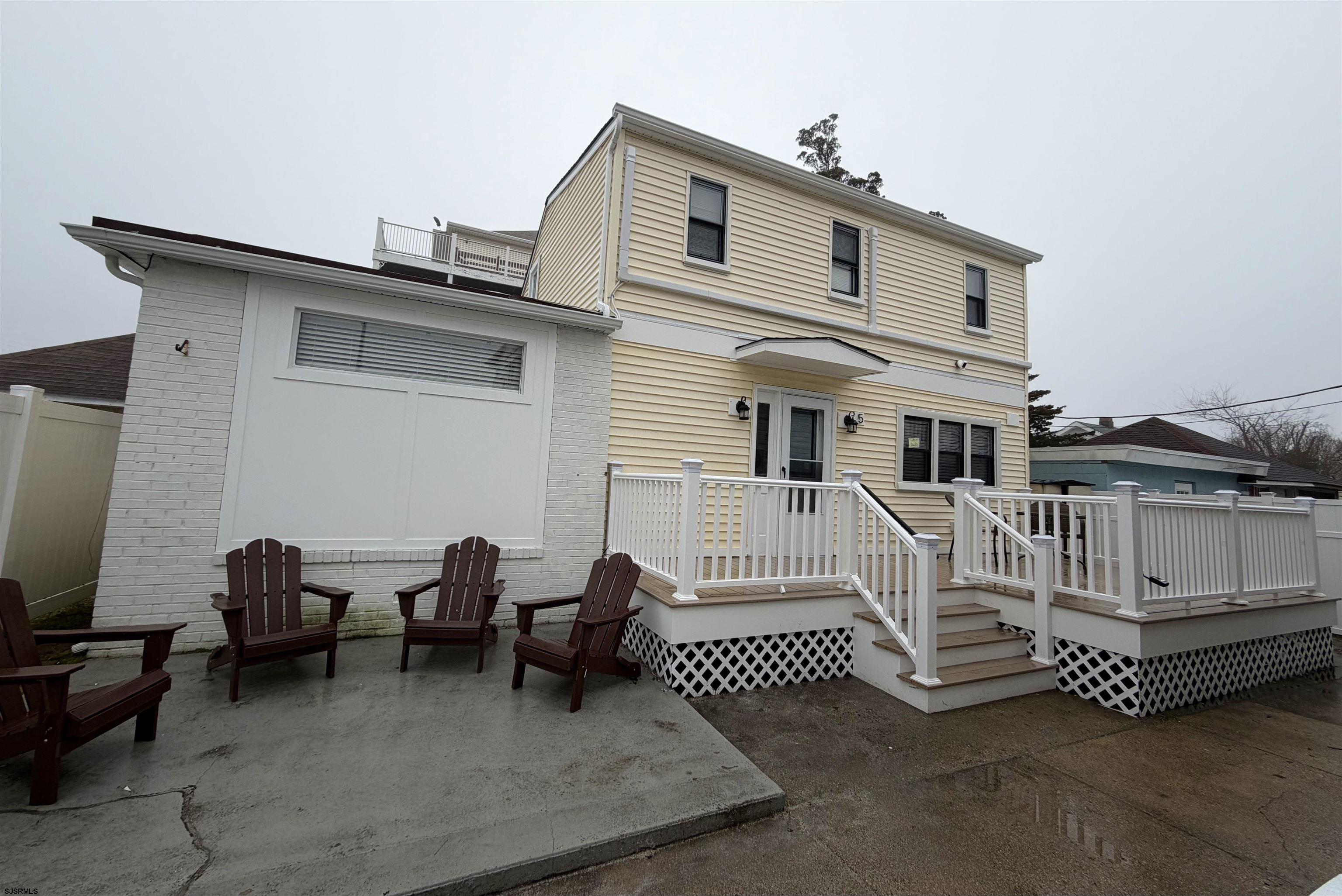 110 West Buttercup Road, Unit 5 Wildwood Crest, NJ 08260 - Photo 2 of 31 a view of a patio with a table and chairs