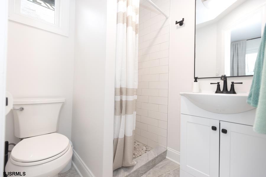 110 West Buttercup Road, Unit 5 Wildwood Crest, NJ 08260 - Photo 22 of 31 a bathroom with a toilet a sink and a shower