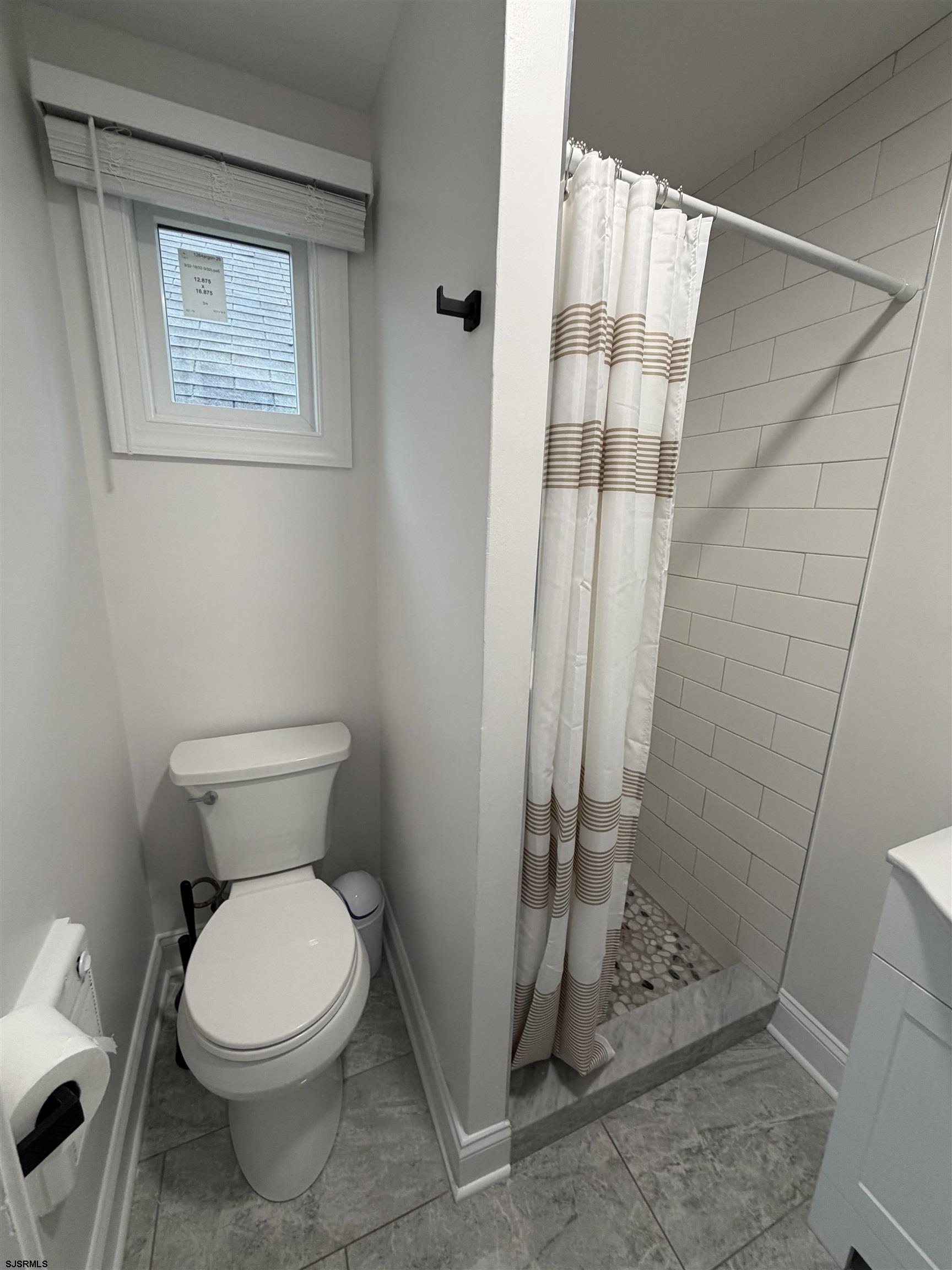 110 West Buttercup Road, Unit 5 Wildwood Crest, NJ 08260 - Photo 23 of 31 a white toilet sitting next to a shower