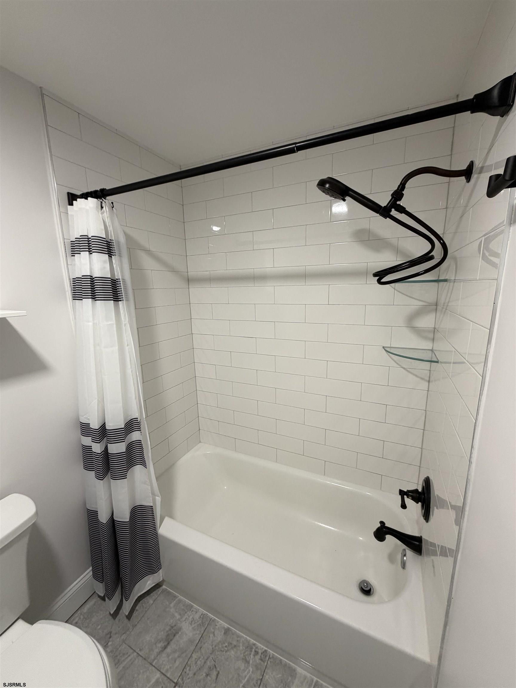 110 West Buttercup Road, Unit 5 Wildwood Crest, NJ 08260 - Photo 28 of 31 a bathroom with a bathtub and a shower