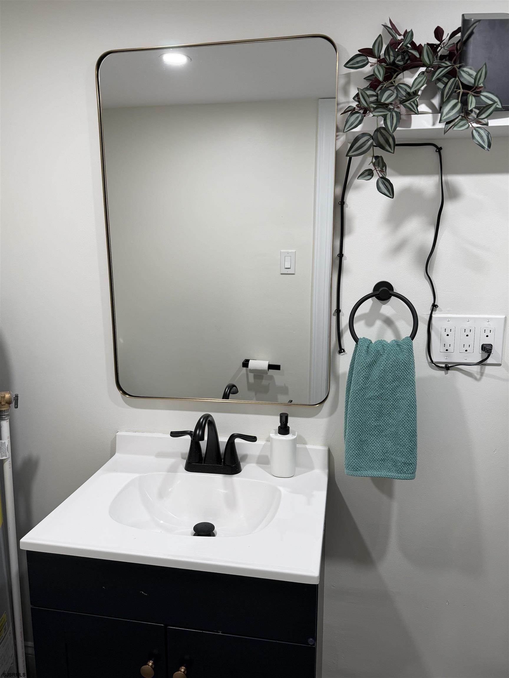 110 West Buttercup Road, Unit 5 Wildwood Crest, NJ 08260 - Photo 30 of 31 a bathroom with a sink and mirror