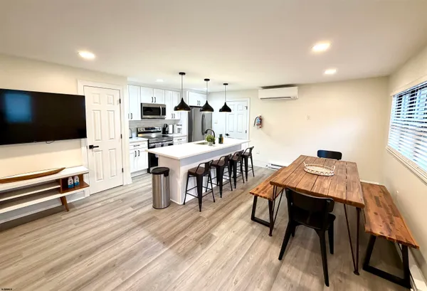 a kitchen with stainless steel appliances a stove a sink a microwave and refrigerator