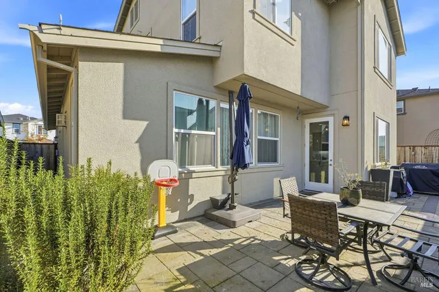 a view of a pathway of a house with wooden fence