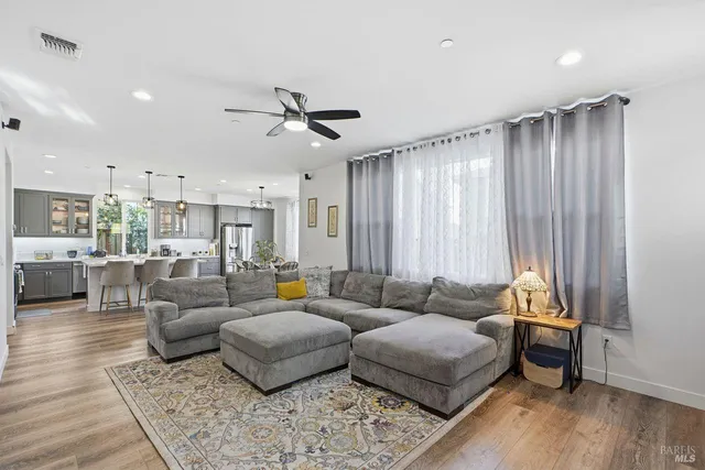 a kitchen with a sink a stove and chairs