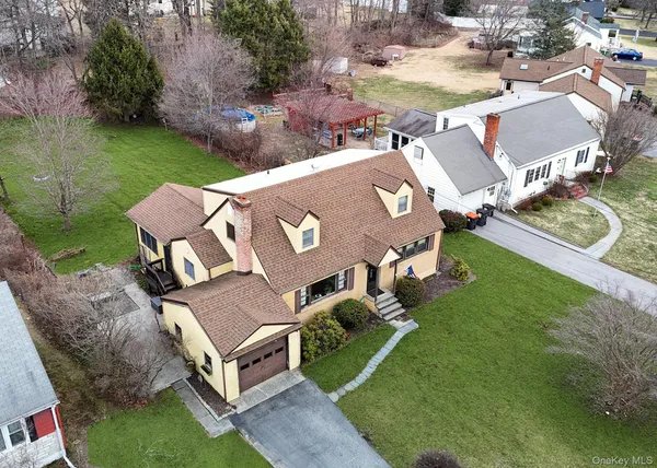 an aerial view of a house with garden space and lake view