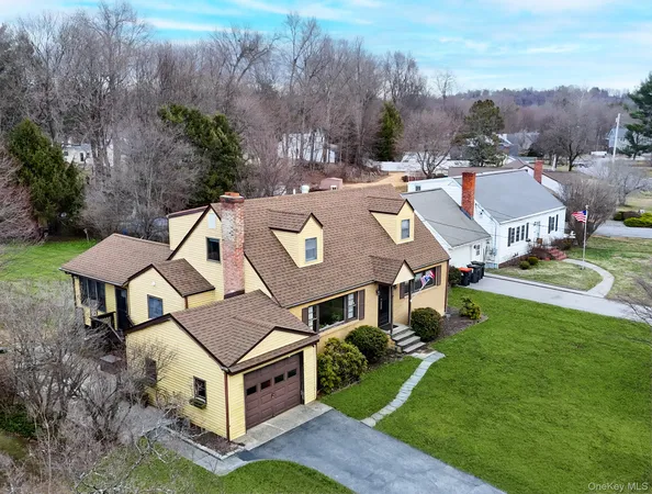 an aerial view of a house with swimming pool garden view and a lake view