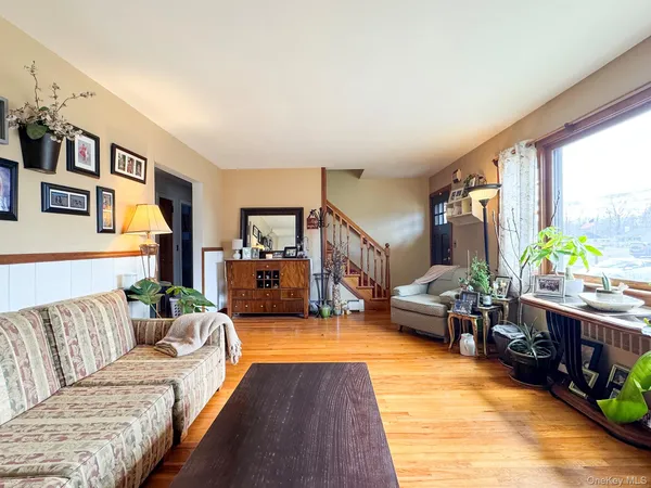 a living room with furniture and painting on the wall