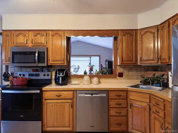 a kitchen with stainless steel appliances granite countertop a sink stove and microwave