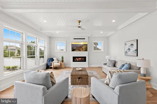 a view of a kitchen with a sink and dishwasher with wooden floor