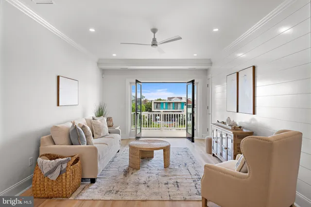 a bedroom with a large bed and wooden floor