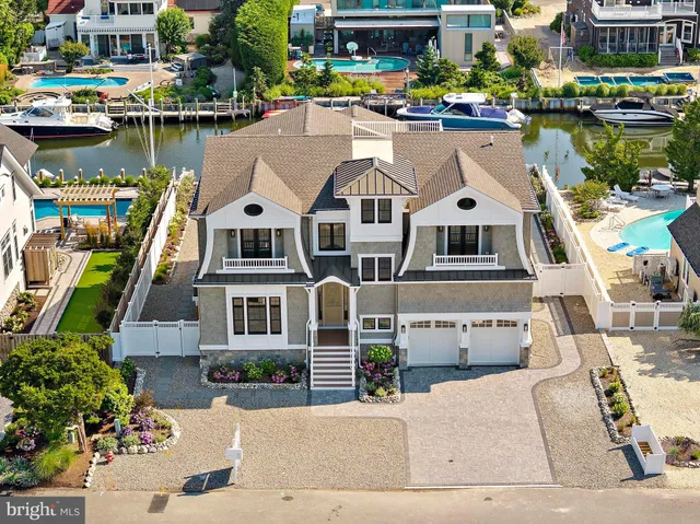 a view of a dining room and livingroom with furniture wooden floor a chandelier