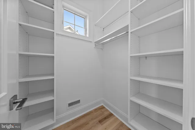 a bathroom with a granite countertop sink toilet and a mirror