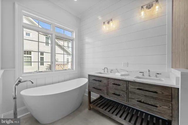 a bathroom with a granite countertop toilet sink and mirror