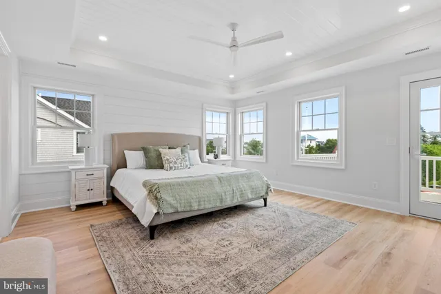 an aerial view of a city with lots of residential buildings ocean and mountain view in back