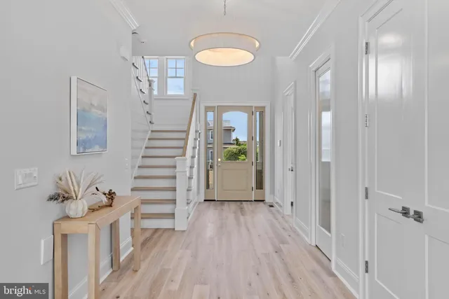 a view of a hallway with wooden floor and entryway