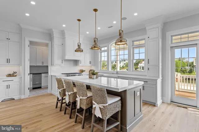 a kitchen with stainless steel appliances a sink a stove and cabinets