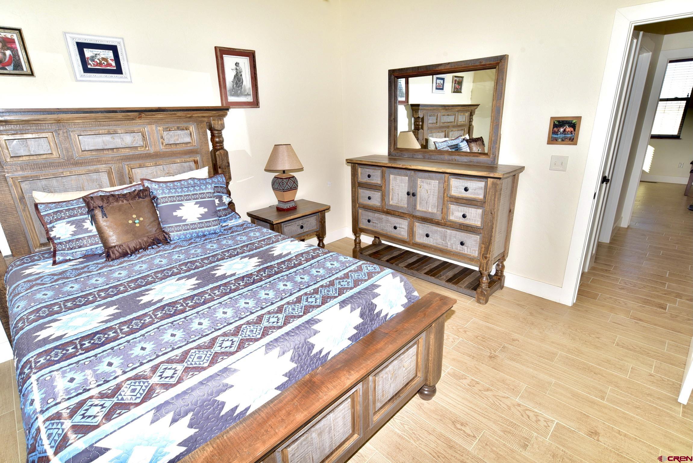 4615 2000th Road Delta, CO 81416 - Photo 22 of 35 a bedroom with a bed and a dresser in it