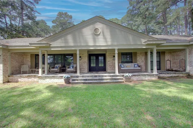 a view of a house with a yard patio and swimming pool