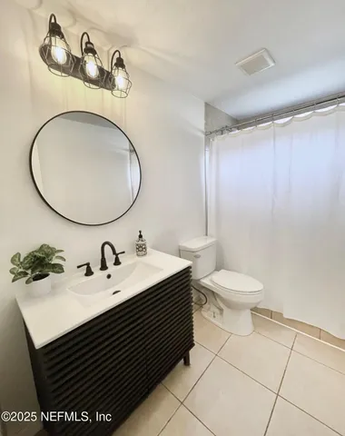 a bathroom with a sink mirror vanity and toilet