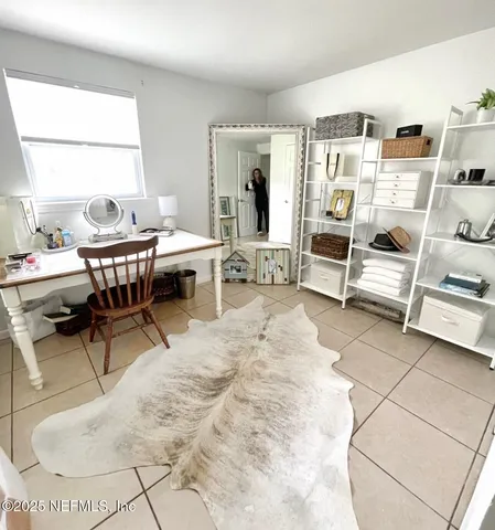 a living room with furniture a dining table and a large window