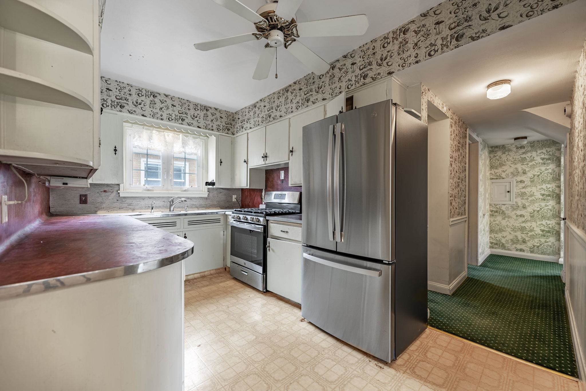 2705 Rural Street Rockford, IL 61107 - Photo 13 of 31 a kitchen with stainless steel appliances granite countertop a refrigerator a sink dishwasher a stove and a dining table with wooden floor