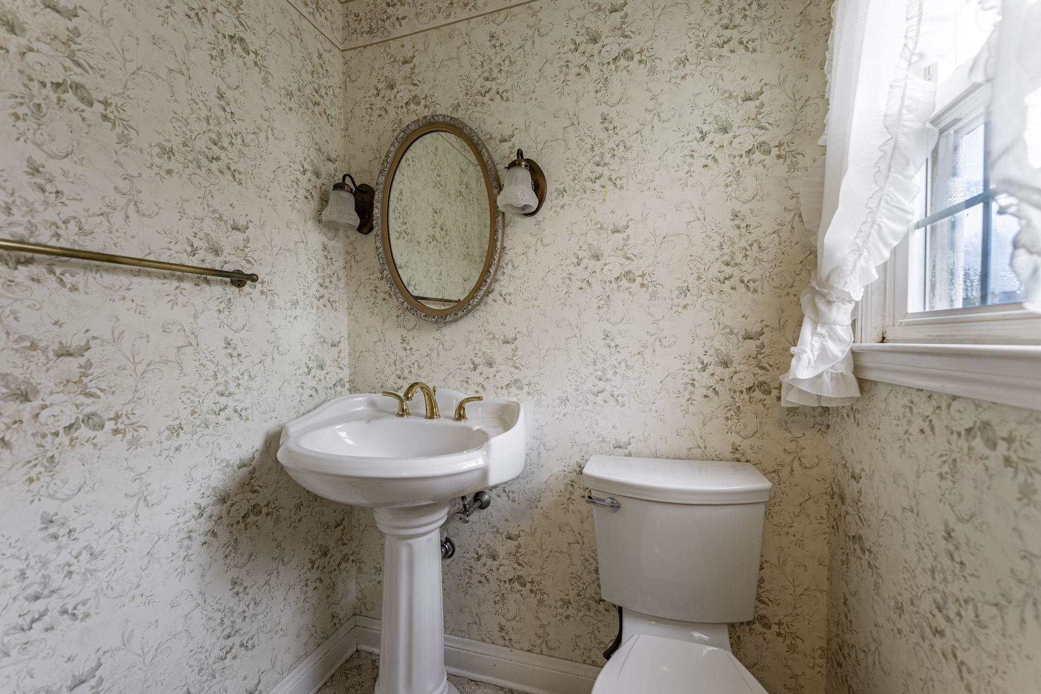 2705 Rural Street Rockford, IL 61107 - Photo 23 of 31 a bathroom with a sink a toilet and a mirror
