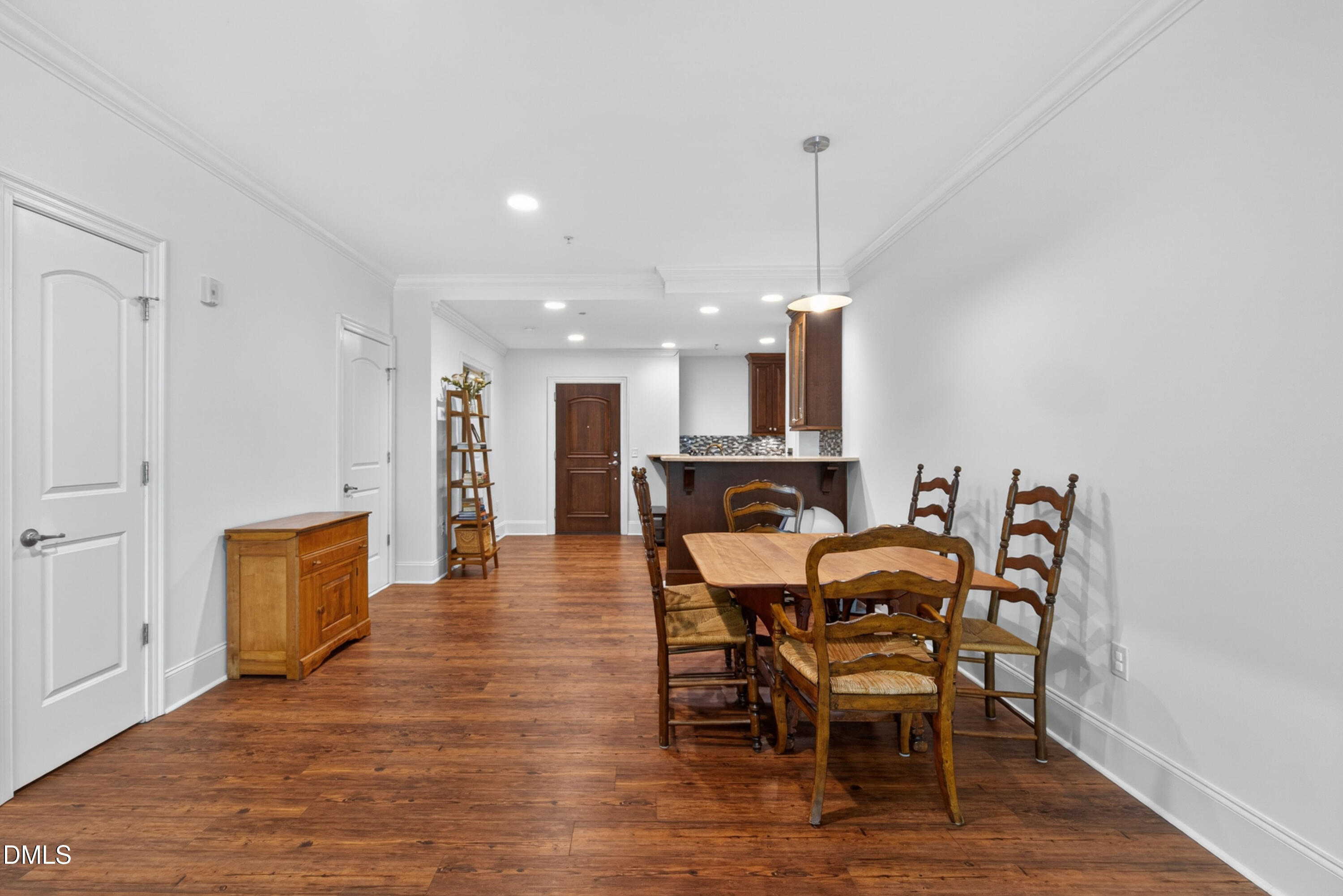 710 Independence Place, Unit 104 Raleigh, NC 27603 - Photo 12 of 34 a view of a dining room with furniture and wooden floor