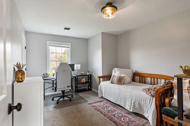 a bedroom with furniture and a window