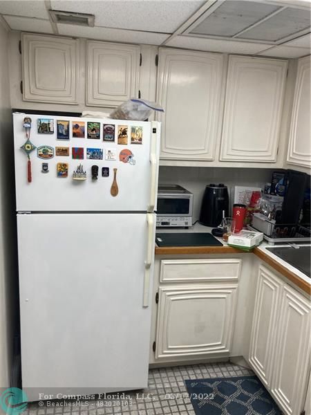 1777 Southeast 15th Street, Unit 312 Fort Lauderdale, FL 33316 - Photo 17 of 17 a white refrigerator freezer sitting inside of a kitchen