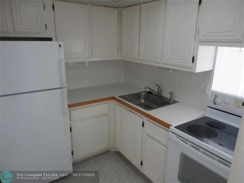1777 Southeast 15th Street, Unit 312 Fort Lauderdale, FL 33316 - Photo 5 of 17 a kitchen with a sink and cabinets