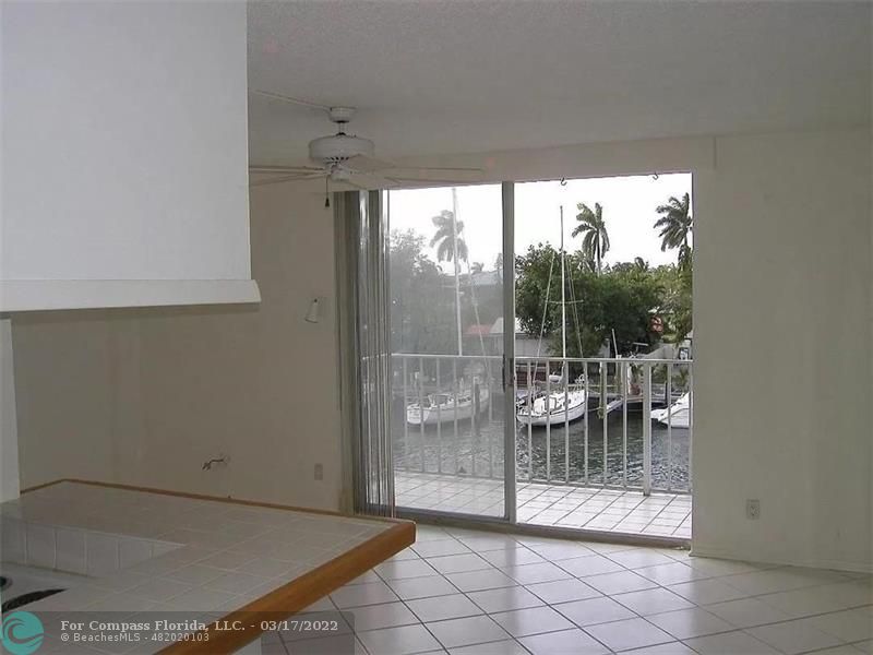 1777 Southeast 15th Street, Unit 312 Fort Lauderdale, FL 33316 - Photo 6 of 17 a view of a room with a glass door and porch