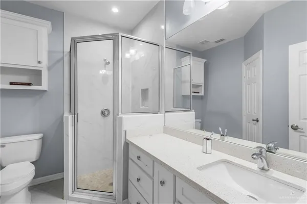 a bathroom with a sink toilet and shower