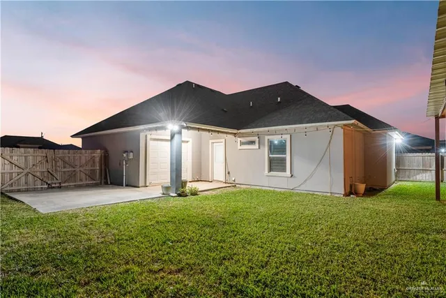 a backyard of a house with table and chairs