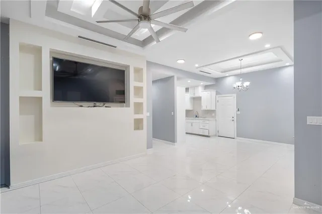a view of a livingroom with an empty space and a ceiling fan
