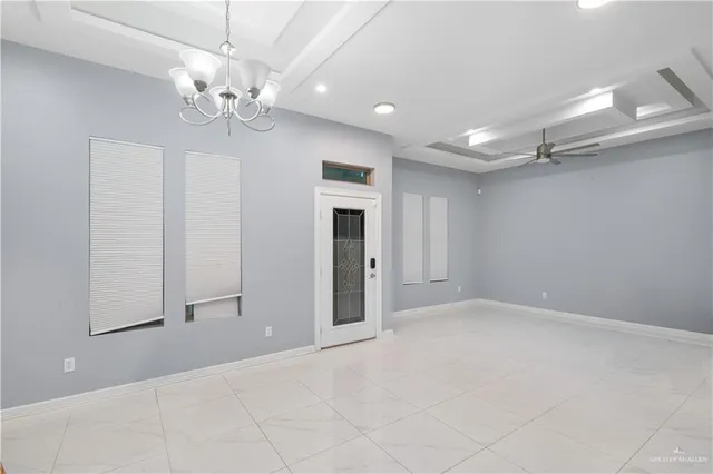 wooden floor in an empty room with a chandelier