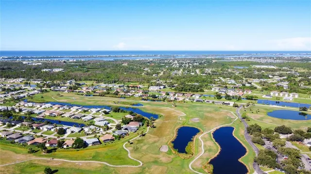 a dining room with furniture a chandelier and wooden floor