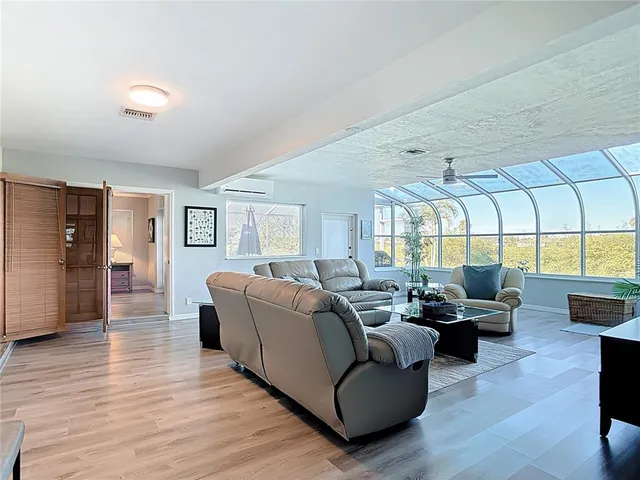 a kitchen with granite countertop a stove top oven a sink dishwasher a refrigerator and cabinets with wooden floor