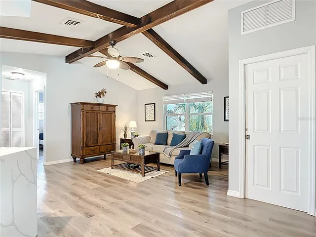 a kitchen with granite countertop a sink white cabinets and white appliances
