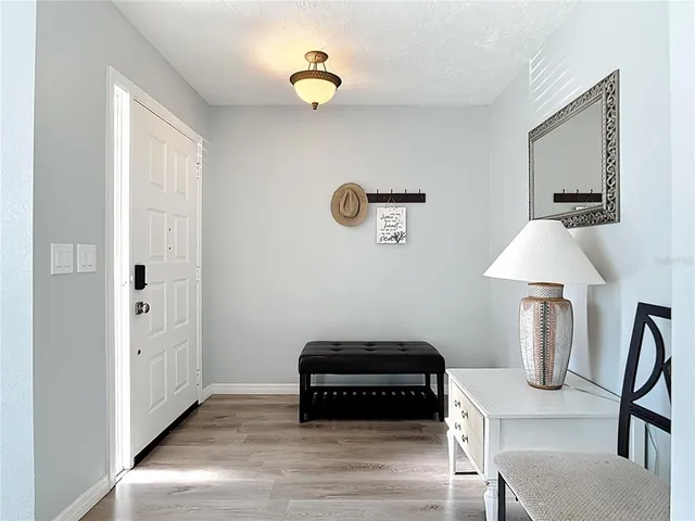 a spacious bedroom with a bed and a flat tv screen