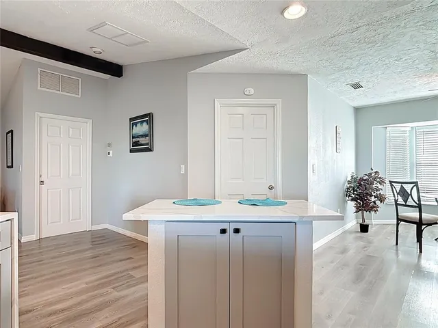 a bathroom with a granite countertop sink a vanity and a mirror